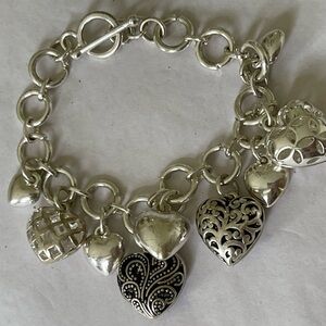 Loaded silver tone heart charm bracelet